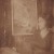 Фрида Рабкина позирует на фоне своего портрета работы Льва Зевина, Конец 1920-х